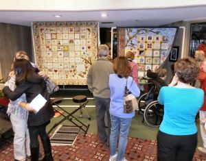 Attendees seeing the quilt for the first time.